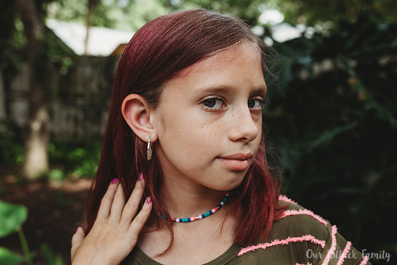 young girl wearing earrings
